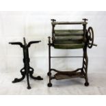 A cast iron table base, of scroll design, together with a cast iron and wooden clothes mangle (2)