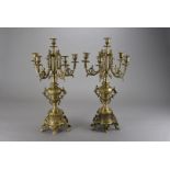 A pair of brass five branch candelabra, in the late Victorian rococo style with vase shaped