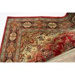 A modern Belgian machine made wool Persian style carpet, in gold and red, 301 cm x 201 cm
