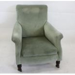 A late 19th century Howard style armchair, in green upholstery and turned supports on brass and