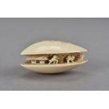 A small Meiji period carved ivory clam's dream, with figures beneath the pines and cottage visible
