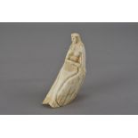 A 19th century whale tooth scrimshaw carving, modelled as a mermaid with clasped hands 13 cm H two