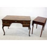 A Queen Anne style walnut writing table, with herringbone inlay, cascade front and shell carved