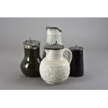 Two moulded Victorian stoneware jugs, with pewter lids, one with edelweiss and leaf design