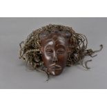 An early 20th century Gabon ancestor Punu face mask, with rope hair, the mask 18 cm H, plus hair