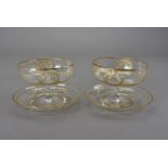 A set of six Edwardian sundae dishes, with saucers, decorated with gilt wreaths, swags and