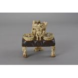 A Napoleonic prisoner-of-war carved bone desk stand, perhaps denoting a religious festival,