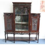 An Edwardian mahogany display cabinet, the central glazed panel door with two shelf interior flanked