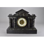 A 19th century black slate mantle clock, the Arabic dial flanked by marble columns 45 cm W