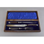 A Victorian oak cased carving set, by Walker and Hall, with antler handles and silver collars,