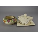 A collection of Clarice Cliff Bizarre table ware, including meat plates, sauce boat, and vegetable