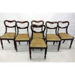 A set of six Victorian rosewood balloon back dining chairs, with scroll curved top rail with gold