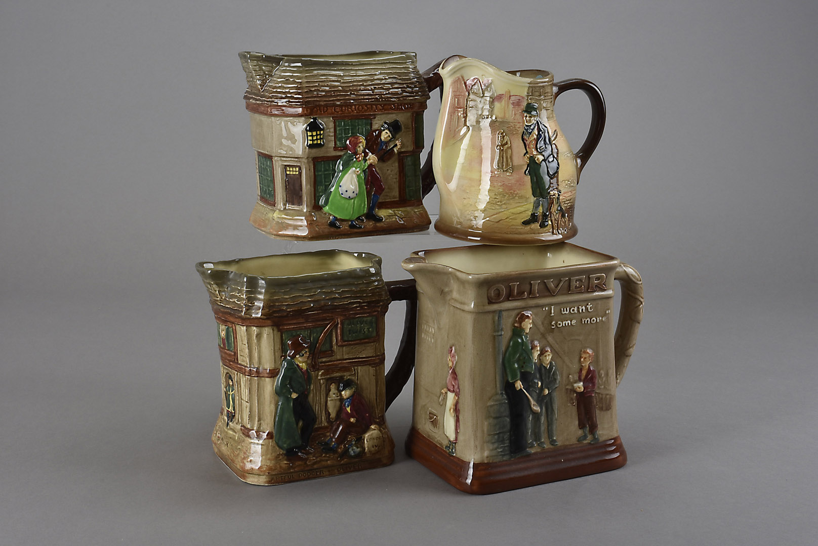 Four Royal Doulton Dickensian jugs, including Bill Sykes, two Oliver Twist, and The Old Curiosity