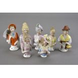 A collection of 14 Continental porcelain half dolls, each wearing period dress, some with hats,