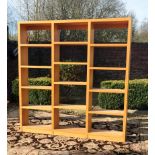 A pair of modernist oak open bookcases, with fixed shelving 199 cm W x 29 cm D x 203 cm H