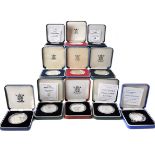 A collection of 22 Royal Mint silver proof commemorative coins, each boxed, most with