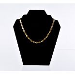 A continental gold and sapphire necklace, having single and double oval links, 17 set with a blue