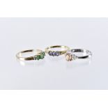 Three modern 9ct gold and gem set rings, one white gold with orange stone, the other yellow gold