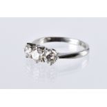 A fine modern platinum and three stone diamond engagement ring, having good quality brilliant cuts