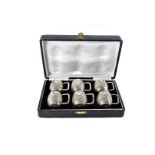 A set of Art Deco period Indian white metal miniature tankards, possibly for liquors, presented in a