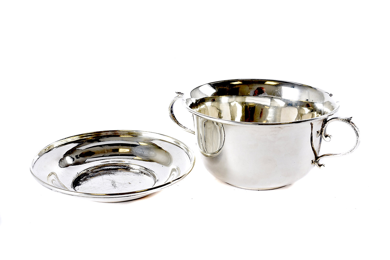 A 1930s silver porringer and cover by C.P & Co, engraved Peter to twin handled cup (2) somewhat