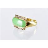 A 1970s Chinese hardstone and diamond dress ring, the oval jade style green stone having applied row