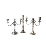 A large collection of Sheffield and silver plated candelabra and candle holders, including one