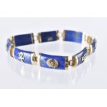 An Egyptian yellow metal and lapis lazuli bracelet