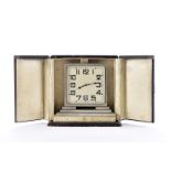 An Art Deco chromed desk clock, in fitted hinged door case, with engraved inscription (2)