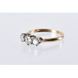 An Art Deco period three stone diamond engagement ring, three brilliant cuts in platinum set, on