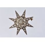 A fine Edwardian period diamond star brooch, the gold starburst mount set with old cushion cut