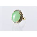 A modern Chinese hardstone and diamond dress ring, in yellow metal mount marked 18k, large green
