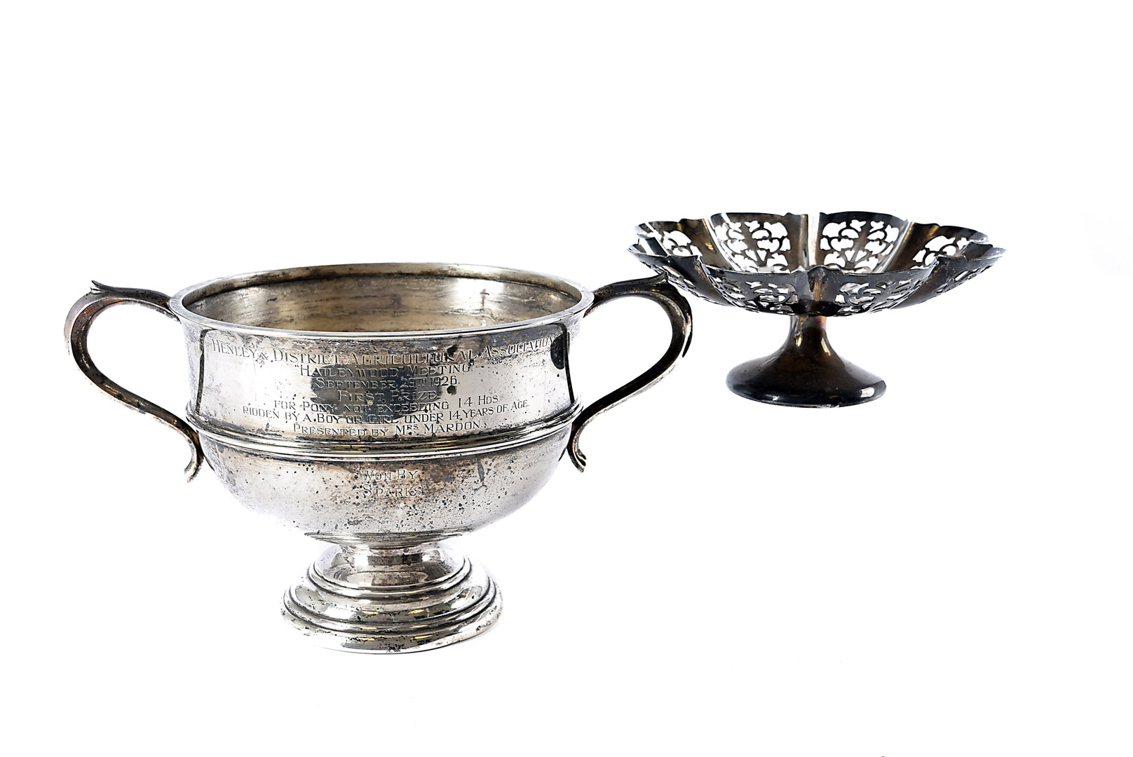 A George V silver twin handled trophy, with engraved presentation inscription, together with a