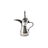 A vintage Middle Eastern or Arabic white metal teapot, typical form and bearing impressed mark to