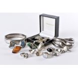 A collection of 17 silver and white metal rings, including a Baltic amber example, others with