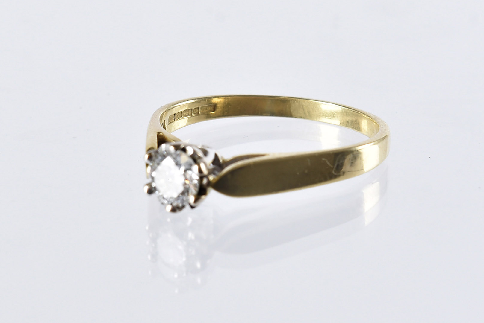 An 18ct gold and diamond solitaire ring, having an 0.4ct brilliant cut, 3.6g and size R