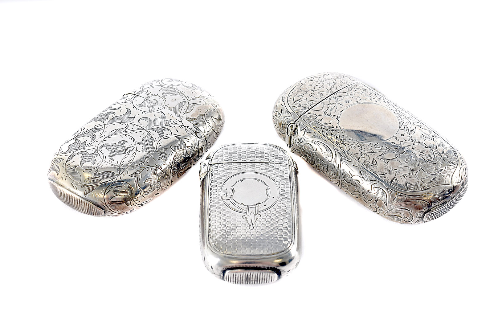 Three Victorian and later silver vesta cases, oval form, two larger, each with engraved designs (3)