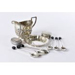 A small group of Victorian and later sliver items, including a milk jug with embossed designs, a