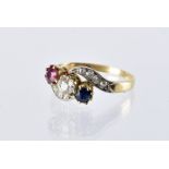 A pretty Art Deco period three stone crossover ring, having an old cut diamond, sapphire and ruby