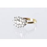 A modern 18ct gold and diamond cluster dress ring, three baguette cuts to centre and surrounded by