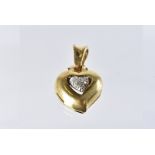 A modern 18ct gold and diamond heart shaped pendant, with hinged back, hallmarked, 5.4g
