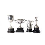 A group of three small silver trophies, including a tyg or three handled example, a goblet and a