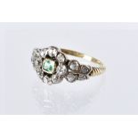 A pretty antique emerald and diamond ring, the square cut green stone with old cut cluster