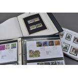 Three modern stamp collection albums, one titled Silver Jubilee Stamps of Queen Elizabeth II,