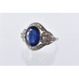 An Art Deco style sapphire and diamond dress ring, the shaped white 18ct gold mount set with a large