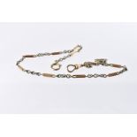 An Edwardian period yellow and white metal lady's watch chain, the fancy links marked 18c with