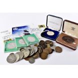 A collection of coins and other items, including several modern silver coins and medals such as a