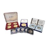 A collection of coins and medals, including a set of four silver gilt Sir Winston Churchill