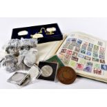 A collection of coins and stamps, including a 1950s onwards school boy stamp album, another