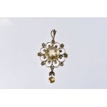 An Edwardian citrine and seed pearl pendant cum brooch, marked 9ct, with large central stone and